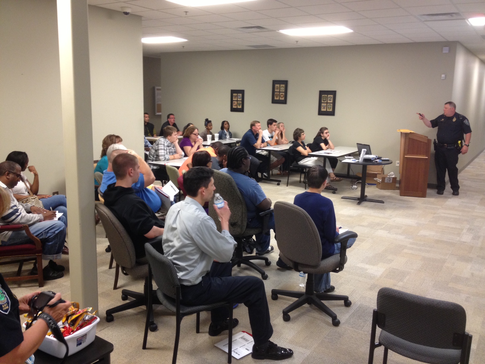 Group of citizens sitting and listening during the Citizen Police Academy lecture.