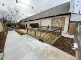 Side of Rooted Trading Building with Quilt Square painted on it and raised patio.