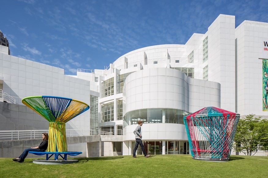 Outdoor picture of the High Museum of Art. Colorful rope sculptures are visible in the foreground.